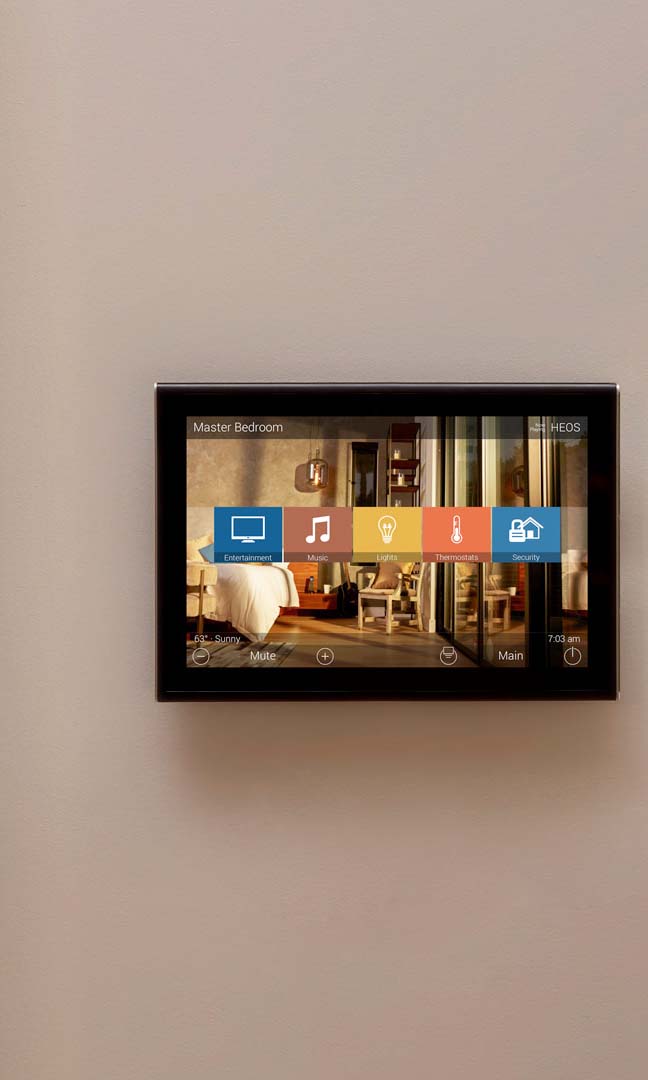 Control4 Touch panel in a able with a traditional home in the background